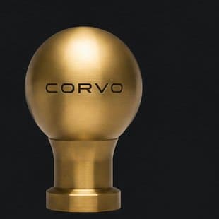 Concept render of the CORVO-001 shift knob in solid brass; mark shown is not final